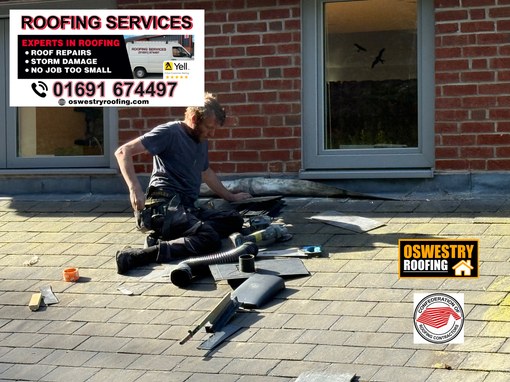 Natural slate roof completed around two fitted roof windows with lead flashing for roofing work in Oswestry