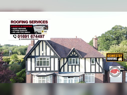 Timber cladding and dark roofline trim fitted to a residential gable above a window for roofing work in Oswestry