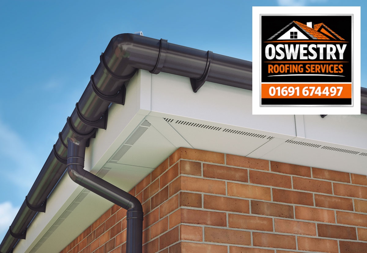 Dark guttering and downpipe with white fascia and soffits