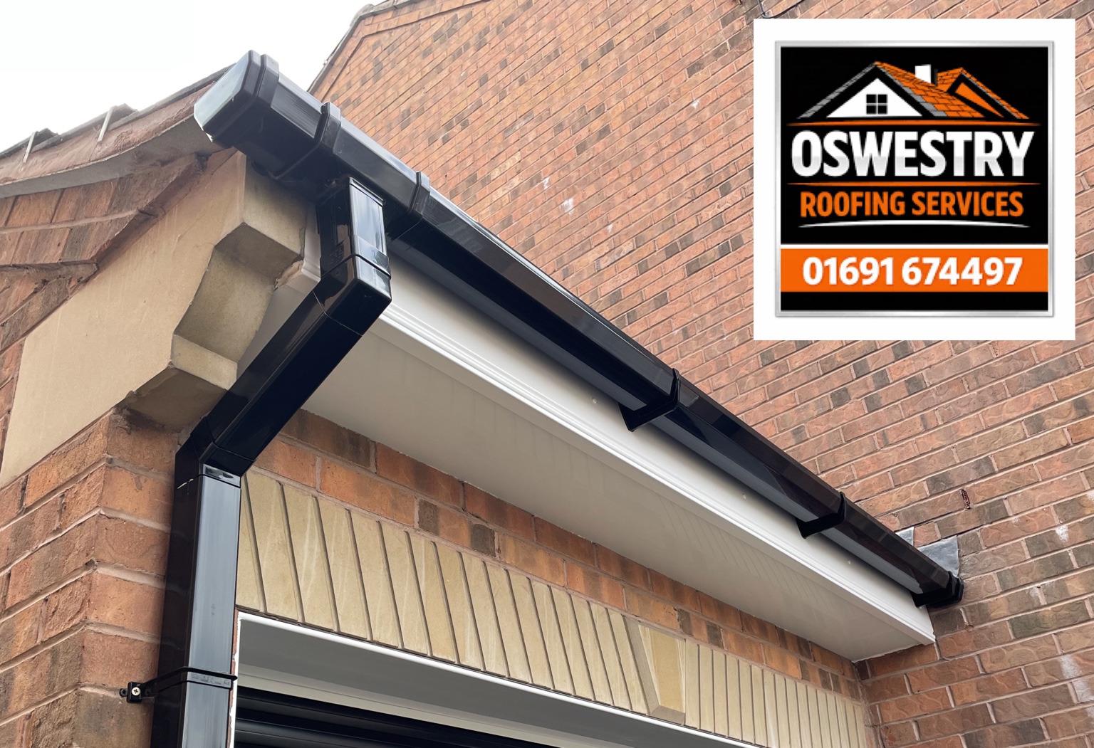 Black gutter and square downpipe with white fascia and soffit