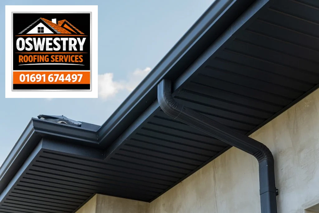Dark gutters, soffits and downpipe fitted beneath a roof